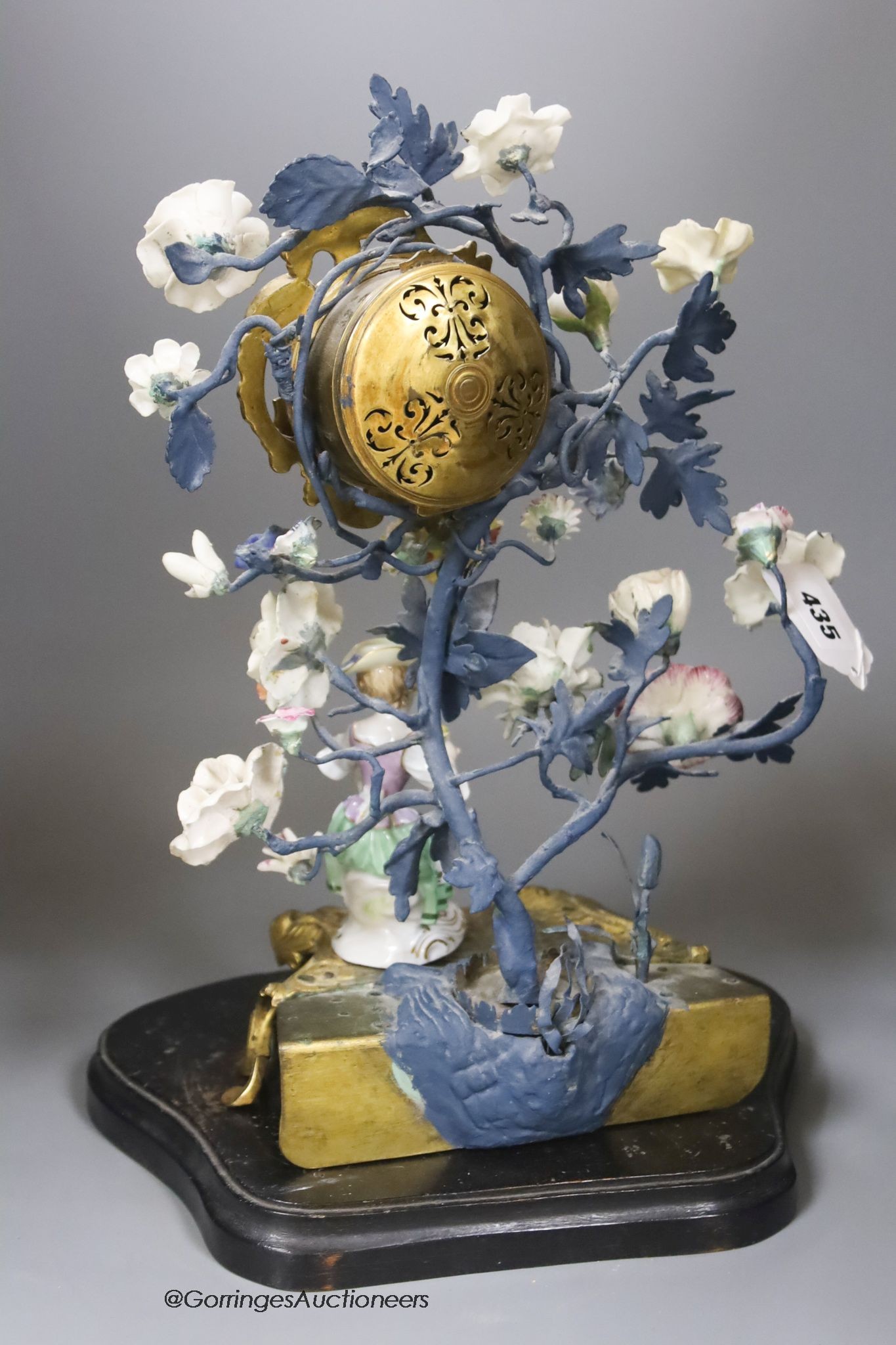 A 19th century and later Continental porcelain and ormolu floral timepiece with Meissen figure